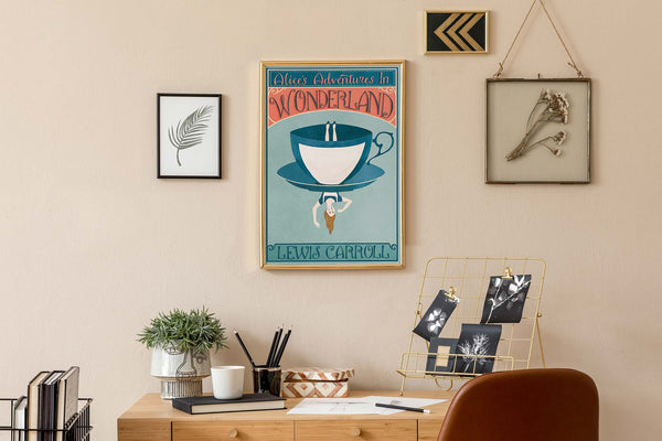 Decorative office setup with a framed Alice In Wonderland poster on the wall, desk, and chair.