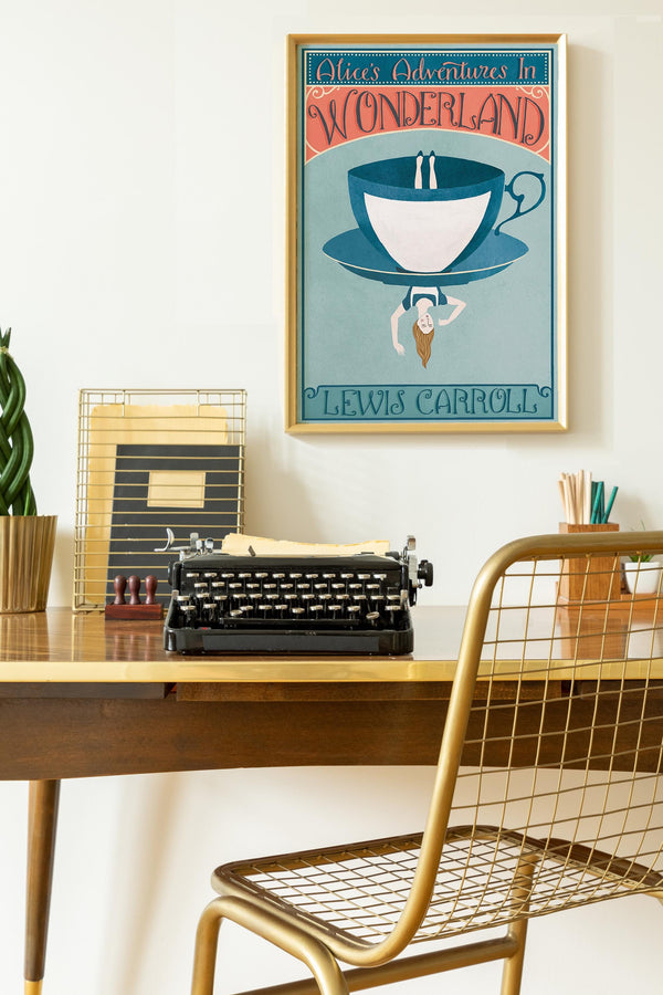 Desk with typewriter, framed poster of 'Alice's Adventures in Wonderland' by Lewis Carroll, and a plant.