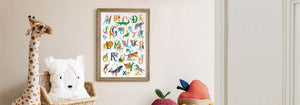 Framed Animal Alphabet poster in kids bedroom with giant giraffe teddy bear. 