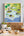 Framed map of English wine estates in Sussex and Kent on a wall above a table with food and decor.