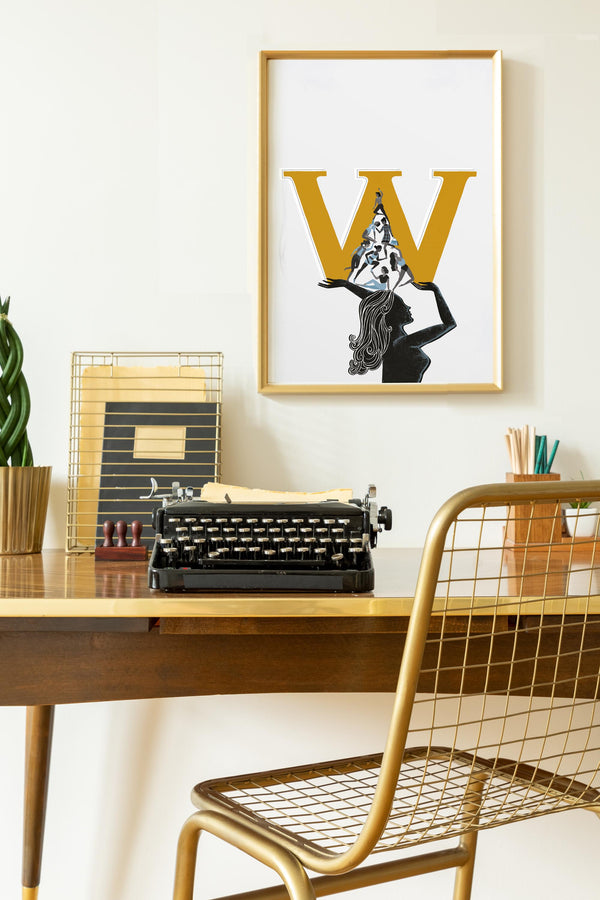 Vintage typewriter on a wooden desk with a framed poster of a woman holding a 'W' above her head.