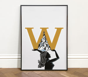 Framed artwork of women with a large gold 'W' and silhouette design on a light grey background.
