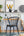 Modern home office with black chair, wooden desk, and International Women's Day Art on wall 