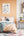 Modern bedroom with orange wall, bed, shelves, desk and Magic A-Z Harry Potter Poster
