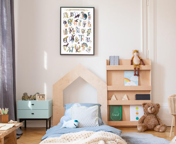 Children's bedroom with wooden bed, bookshelf, and Magic alphabet poster on the wall.