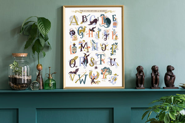Framed Magic alphabet poster on a teal shelf with decorative items against a green wall.
