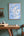 Map of Scotland on a wall above a wooden table with decor items.