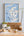 Map of Scotland on a wall above a dining table with decor items.