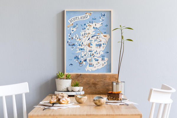 Map of Scotland on a wall above a dining table with decor items.