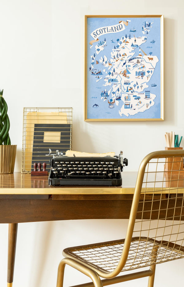 Desk with typewriter, framed map of Scotland, and decorative items.