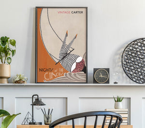 Framed artwork titled 'Nights at the Circus' by Vintage Carter on a shelf with decorative items.