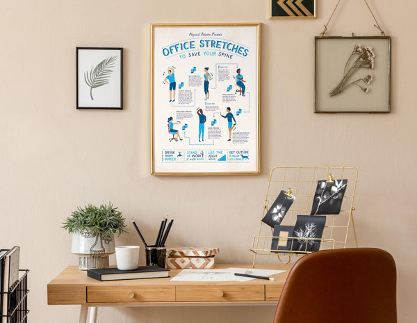 Framed Office Stretches poster on a wall above a desk with office decor elements.