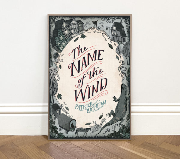 Framed book cover of 'The Name of the Wind' by Patrick Rothfuss on a white wall.