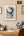 Home office with a desk, chair, and Framed artwork  of The Night Circus by  Erin Morgenstern 