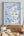 Framed map of Scotland illustration on a wall above a wooden shelf with decorative items.