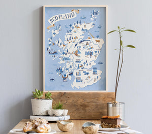 Framed map of Scotland illustration on a wall above a wooden shelf with decorative items.